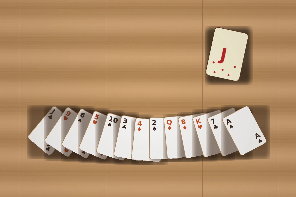Editorial still of thirteen rummy cards being fanned out on a wooden table after the deal.